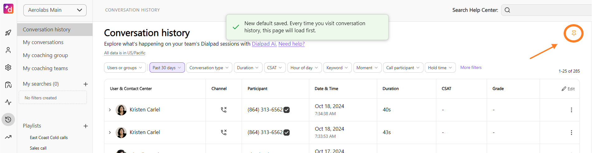 Screenshot of Dialpad's Conversation History page showing a 'New default saved' confirmation message, with an orange arrow and circle highlighting the active pin icon in the upper right.