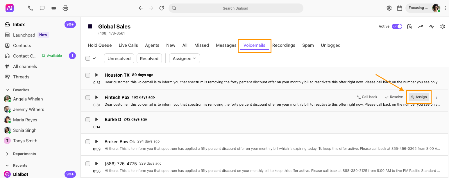 Screenshot of Dialpad open to the 'Voicemails' tab, with an orange box highlighting the tab and an orange arrow pointing to the highlighted 'Assign' button on a voicemail entry.