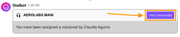 Screenshot of a Dialbot notification message stating a voicemail was assigned, with an orange box and arrow pointing to the purple 'View Voicemails' button.