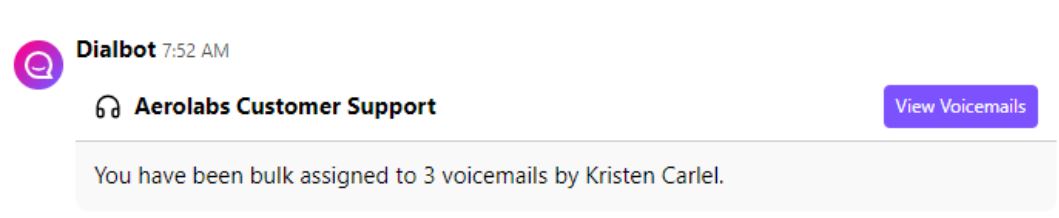 Screenshot of a Dialbot notification message stating that 3 voicemails were bulk assigned by Kristen Carlel, with a purple 'View Voicemails' button for Aerolabs Customer Support.