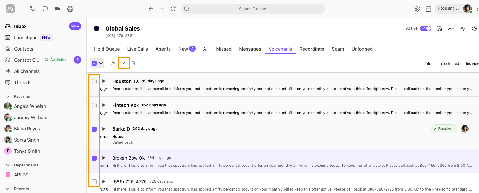 Screenshot of Dialpad open to the Voicemails tab, showing multiple selected voicemails with orange boxes highlighting the selection checkboxes on the left and the top bulk checkmark resolve button.