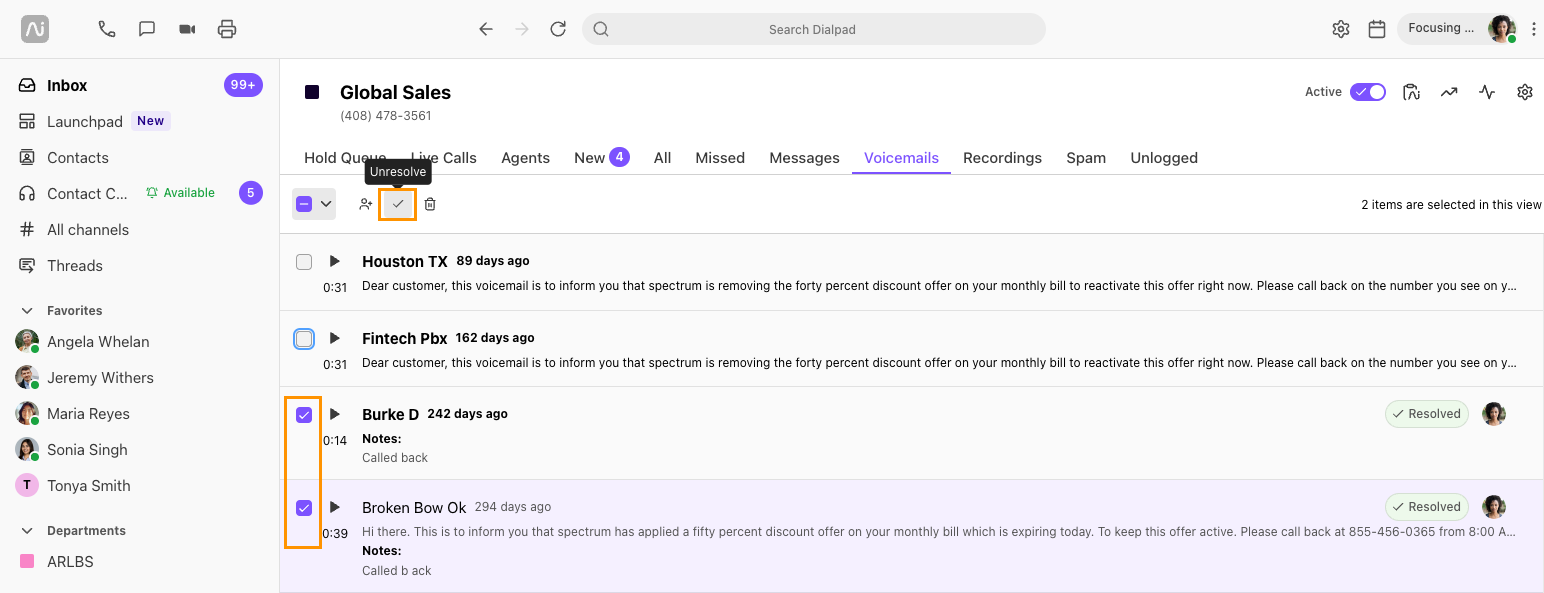 Screenshot of Dialpad open to the Voicemails tab, showing two selected resolved voicemails with orange boxes highlighting the checked boxes on the left and the top bulk 'Unresolve' checkmark button with a tooltip.