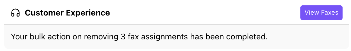 Screenshot of a Dialbot notification message stating that a bulk action to remove multiple fax assignments has been completed, with a purple 'View Faxes' action button.