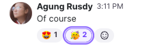 Screenshot of emoji reactions attached beneath a chat message, with a purple outline highlighting a party emoji reaction counter set to 2 next to a smiley face icon.