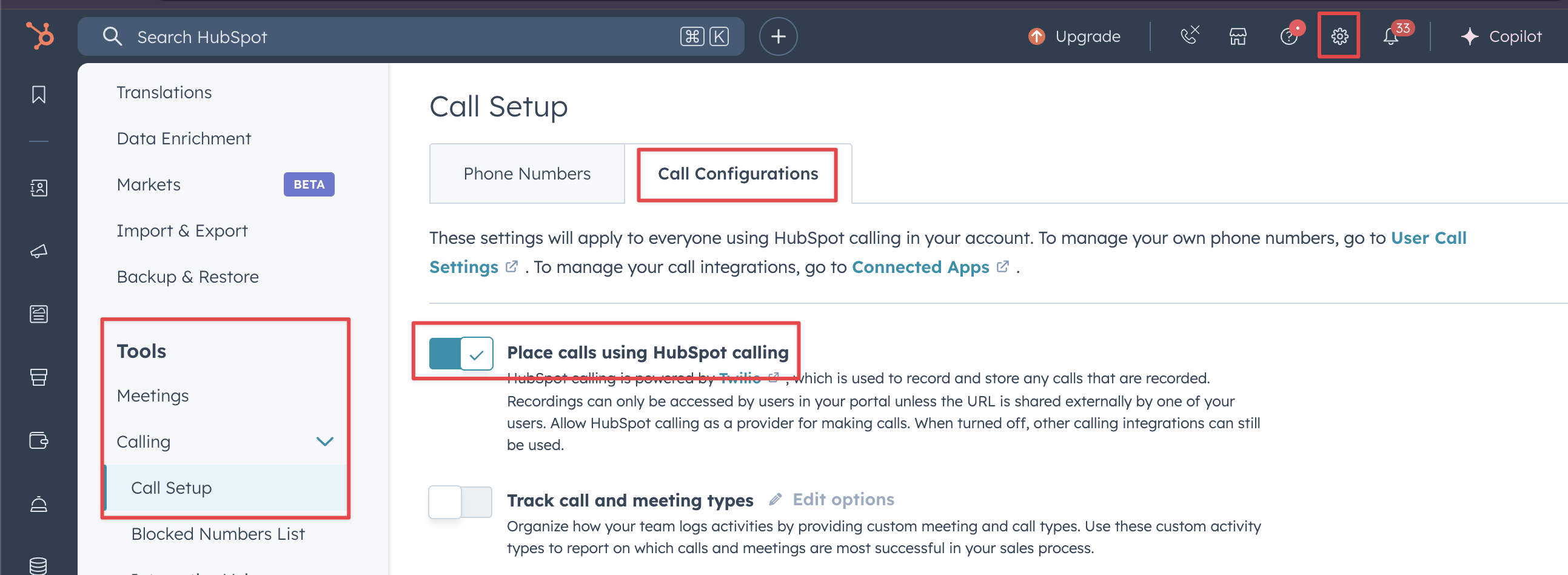 Screenshot of the HubSpot Call Setup settings page, featuring red boxes highlighting the main settings gear icon, Tools > Calling > Call Setup menu options, the Call Configurations tab, and the 'Place calls using HubSpot calling' toggle switch.
