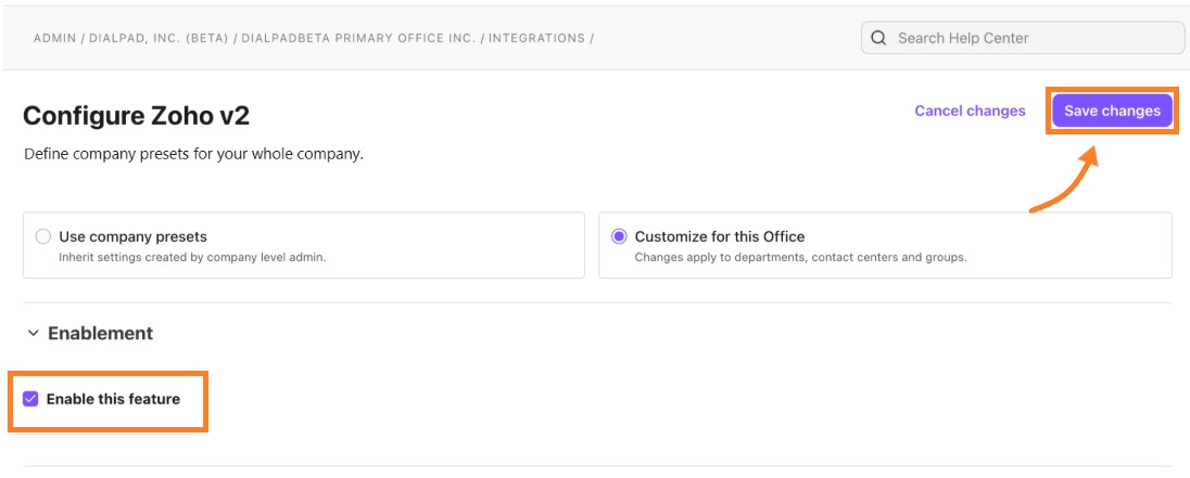 Screenshot of the "Configure Zoho v2" page in the Dialpad Admin Portal, with an orange box highlighting the "Enable this feature" checkbox and an orange box and arrow pointing to the purple "Save changes" button.